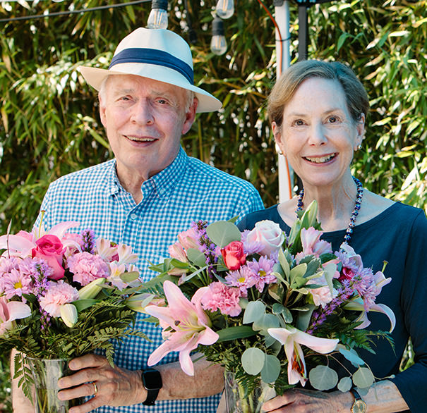 Elderly couple holding flowers