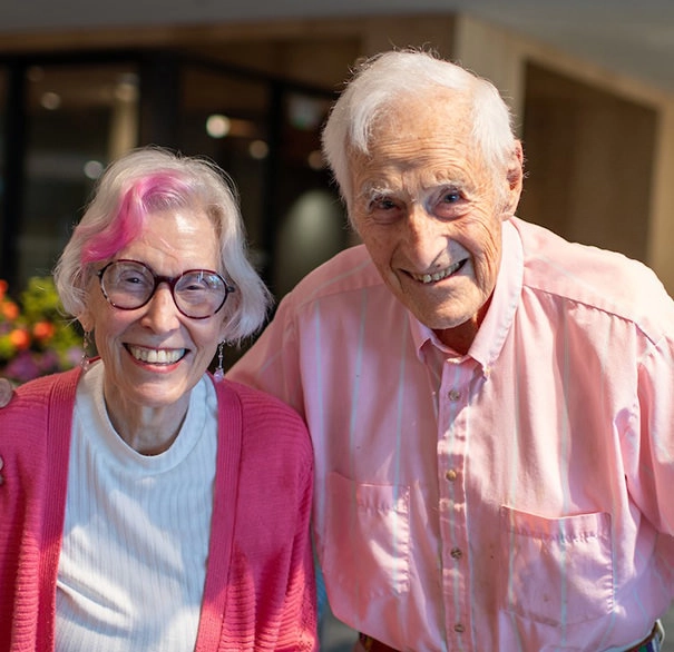 elderly couple wearing pink