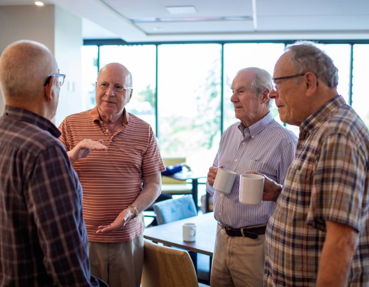 senior men talking in group