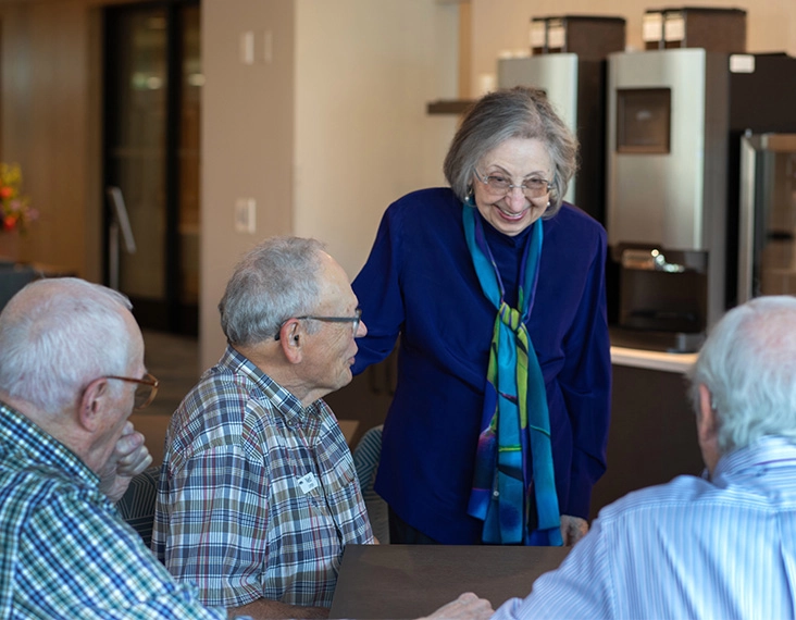 Senior woman talking to group of men