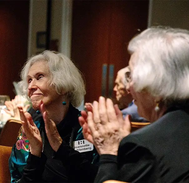 two senior women clapping