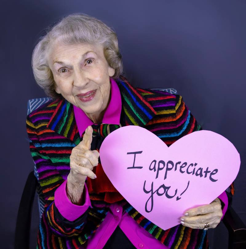 Senior lady holding thank you sign