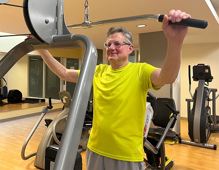 senior man using gym equipment