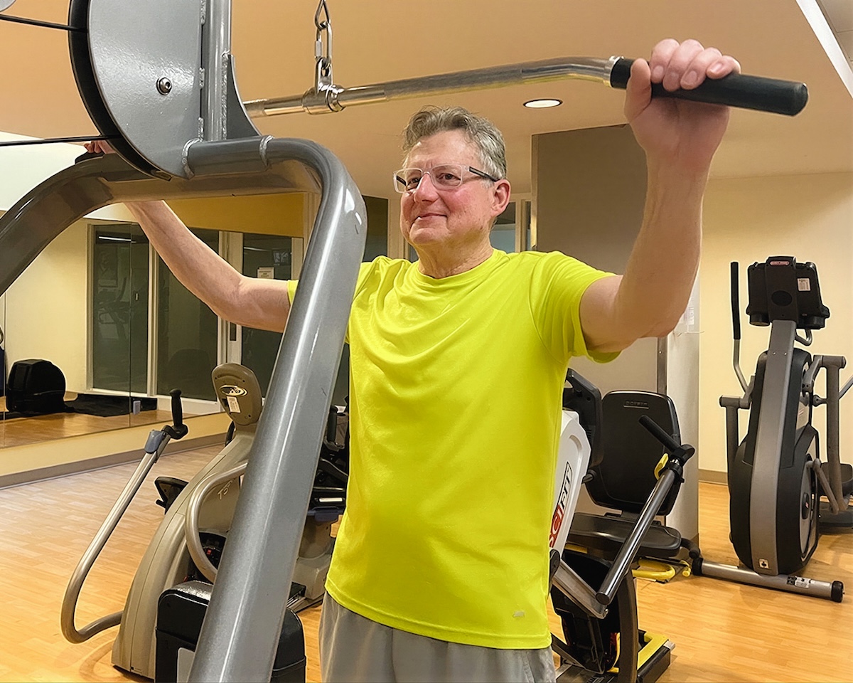 senior man using gym equipment