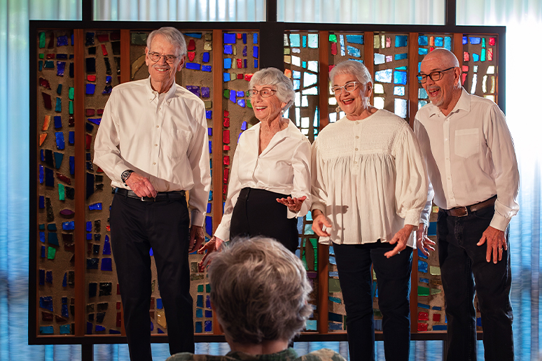 senior council members listen to a vocal group perform
